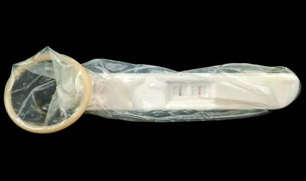 Pregnancy test in condom — Stock Photo, Image