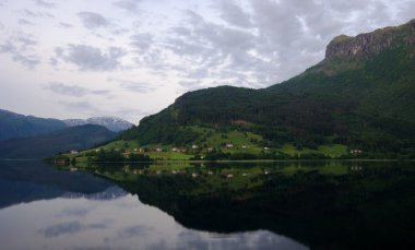 Peaceful village by Hardanger fjord in Norway clipart