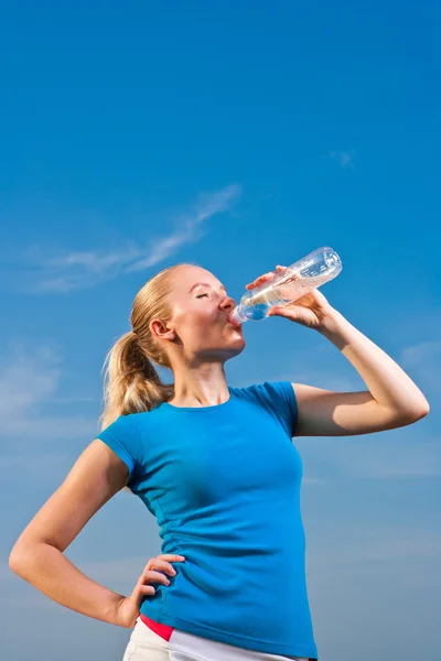 Stock image Young female athlete drinkig water to refresh during a hot weath